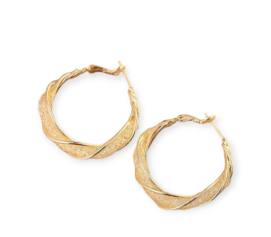 Golden twisted hoop earrings with modern spiral design, perfect for everyday wear or special occasions.