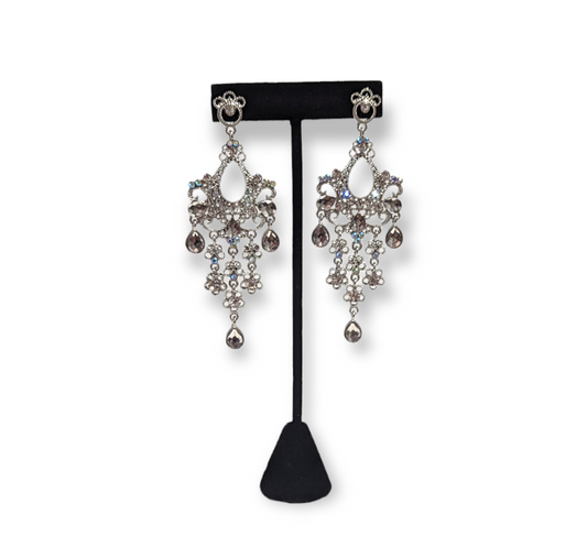 A pair of silver chandelier drop earrings with crystal embellishments.