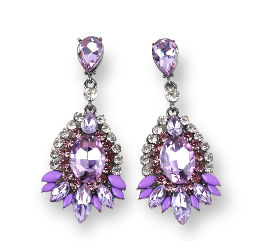 A pair of earrings featuring large purple stones set in a gold-colored, intricately designed frame, with smaller clear stones around the main purple pieces.