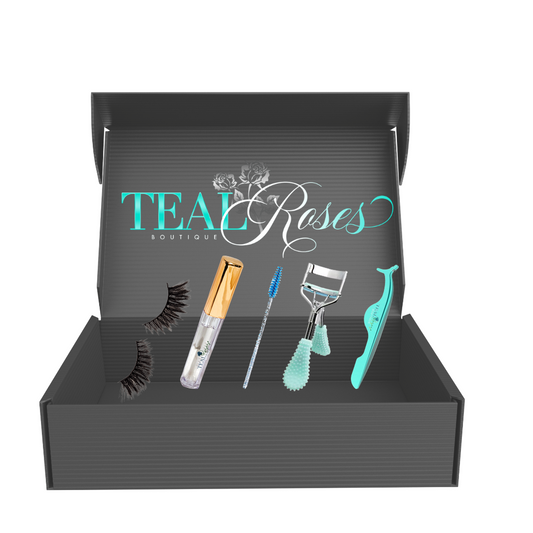 A gift box set containing various eyelash care products, including false eyelashes, an eyelash applicator, a luxury lash curler, eyelash adhesive, and a mini lash wand, all displayed neatly inside the box.