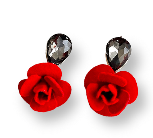 A pair of red, teardrop-shaped earrings with a sparkling black stone at the top and a red velvet flower at the bottom.